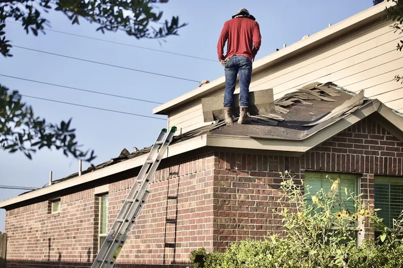 Professional roofer working on a residential roof in Riverlake